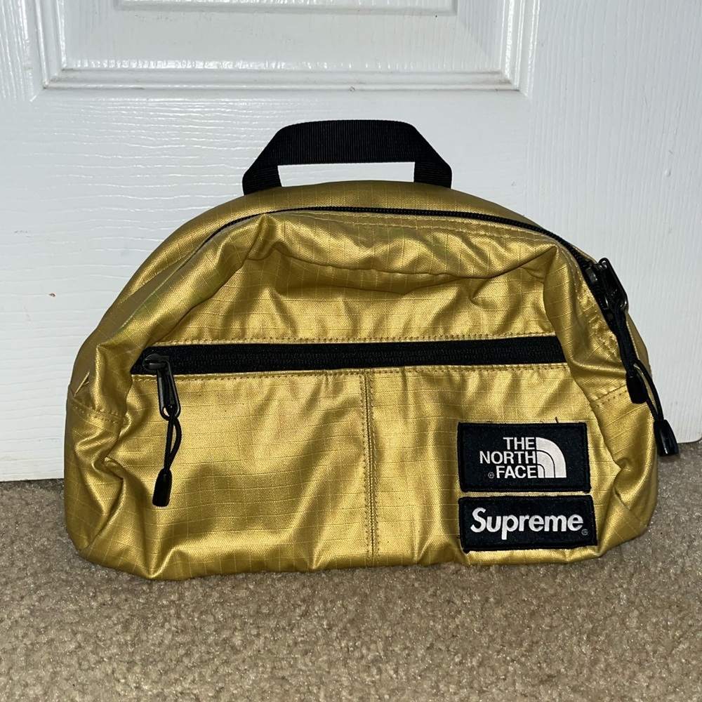 I am selling a Gold Supreme North Face bag that comes with two pockets.
